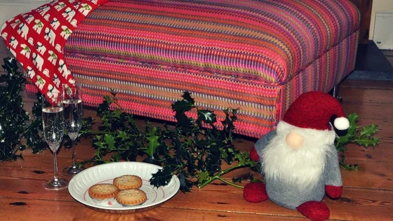 Upholstered footstool with xmas items