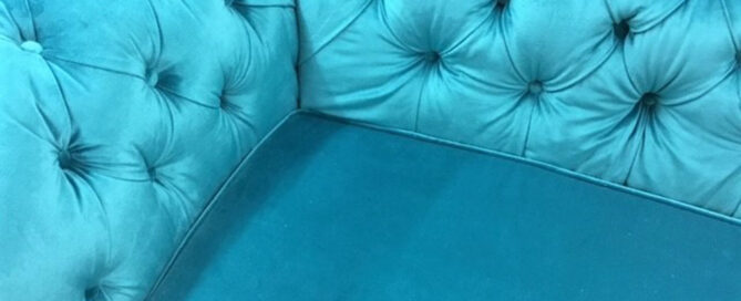 Deep button detail on a velvet Chesterfield sofa