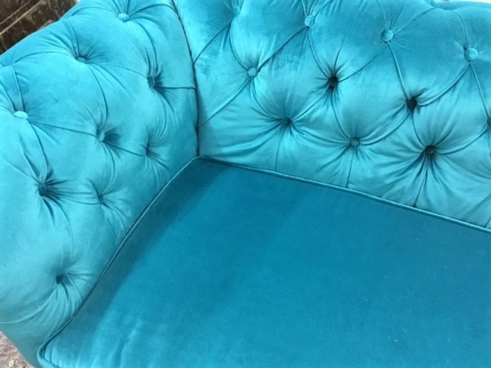 Deep button detail on a velvet Chesterfield sofa