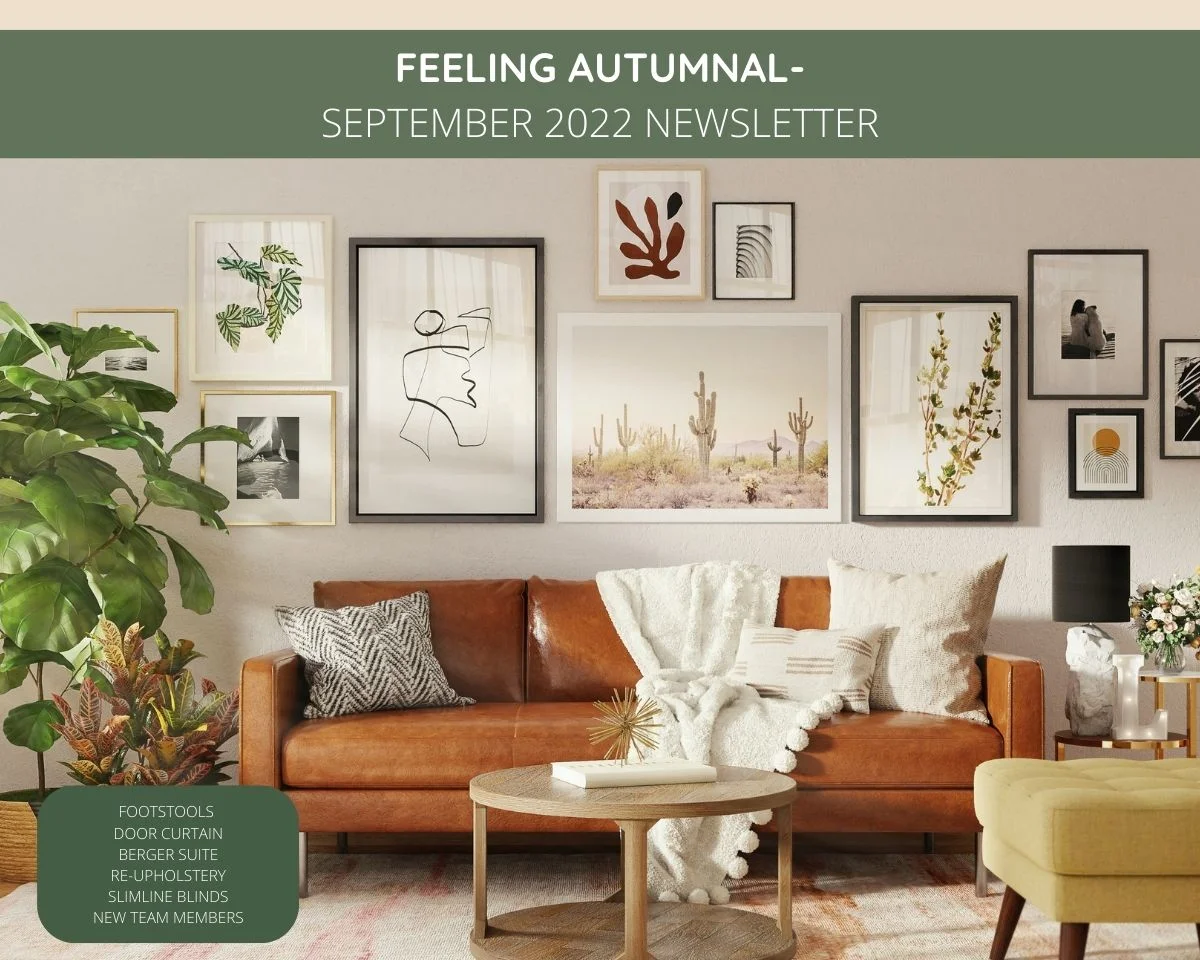 Tan leather sofa, upholstered footstool, green pot plant and coffee table in a lounge