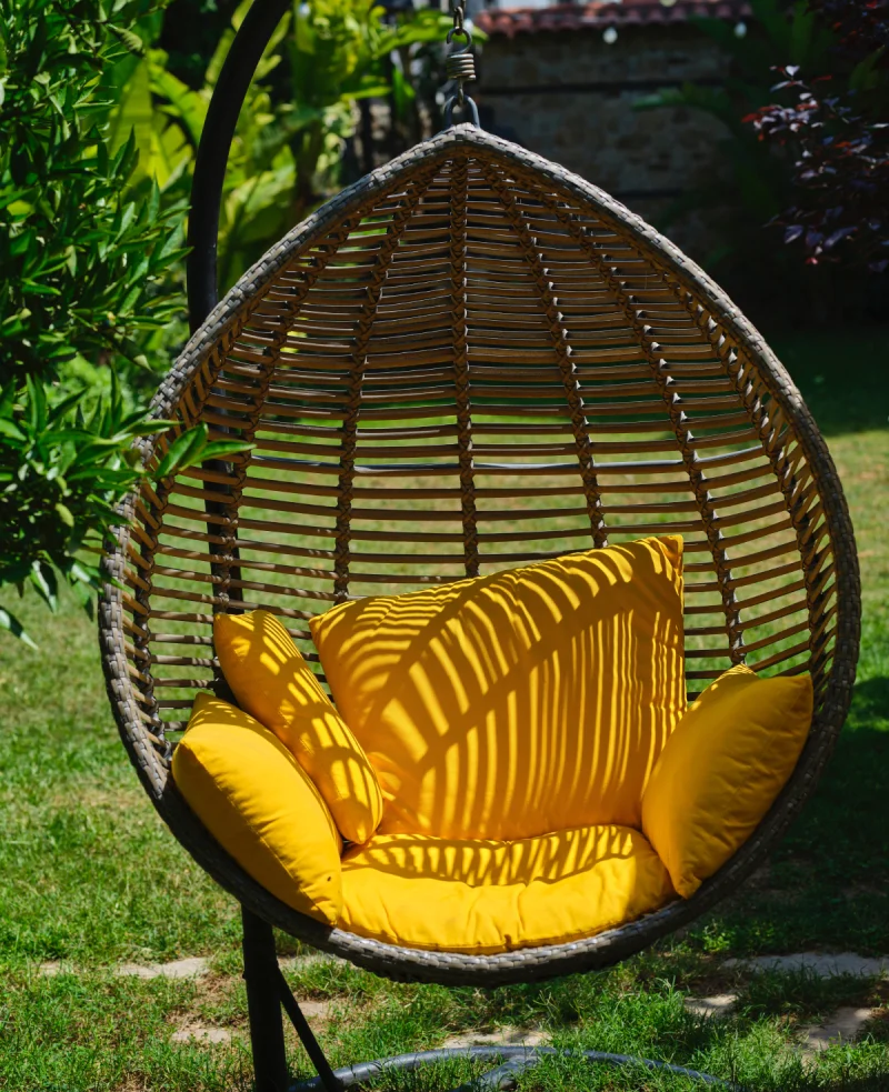 Out door basket swing with yellow cushions